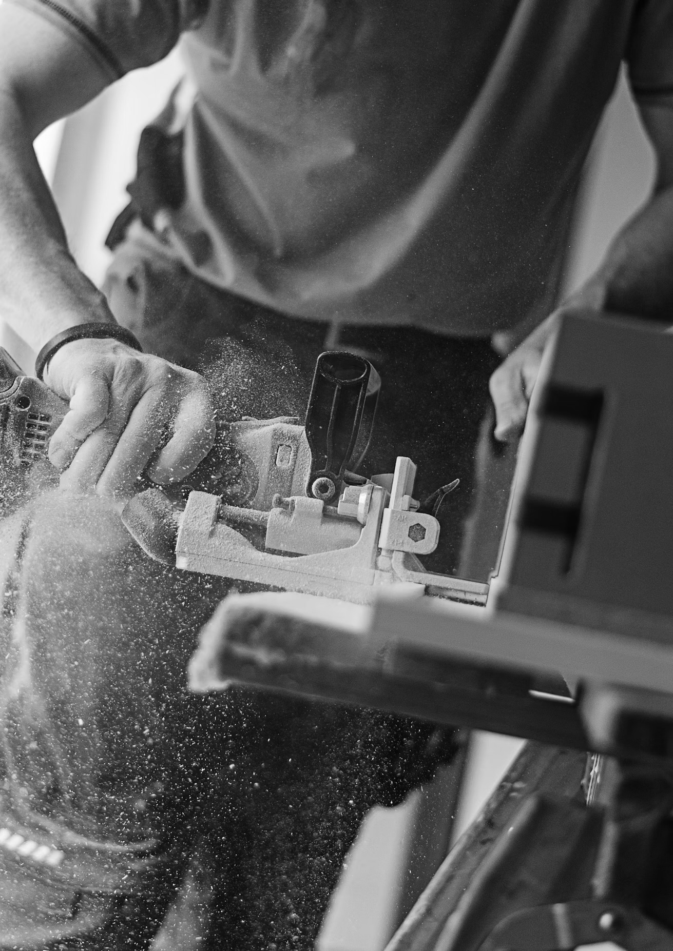 Jo at the workbench, biscuit joiner mid-cut